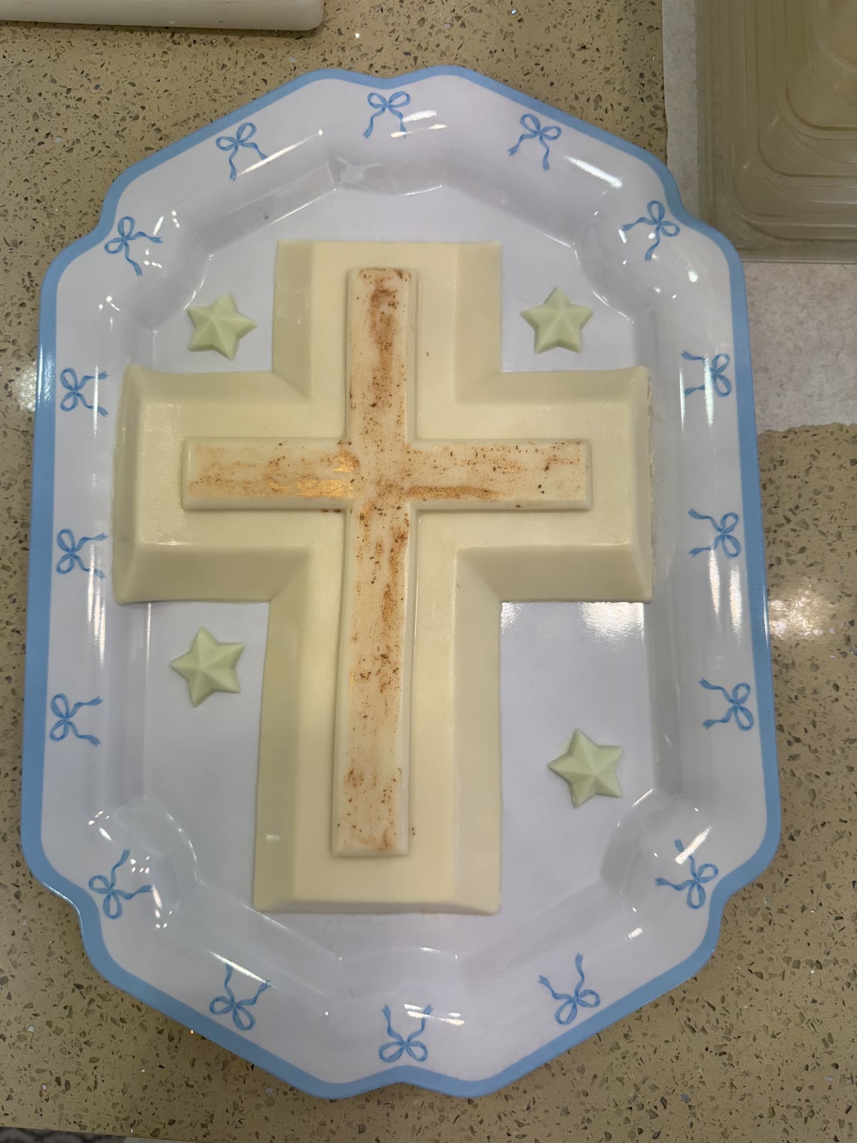 White chocolate cross on a decorated platter for a baptism