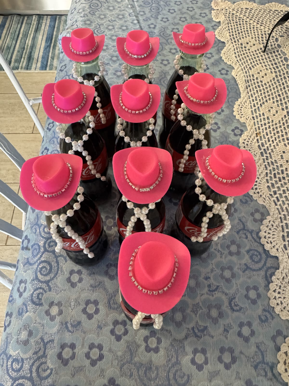 Chocolate-dipped bottles dressed with mini pink cowboy hats and pearl strands