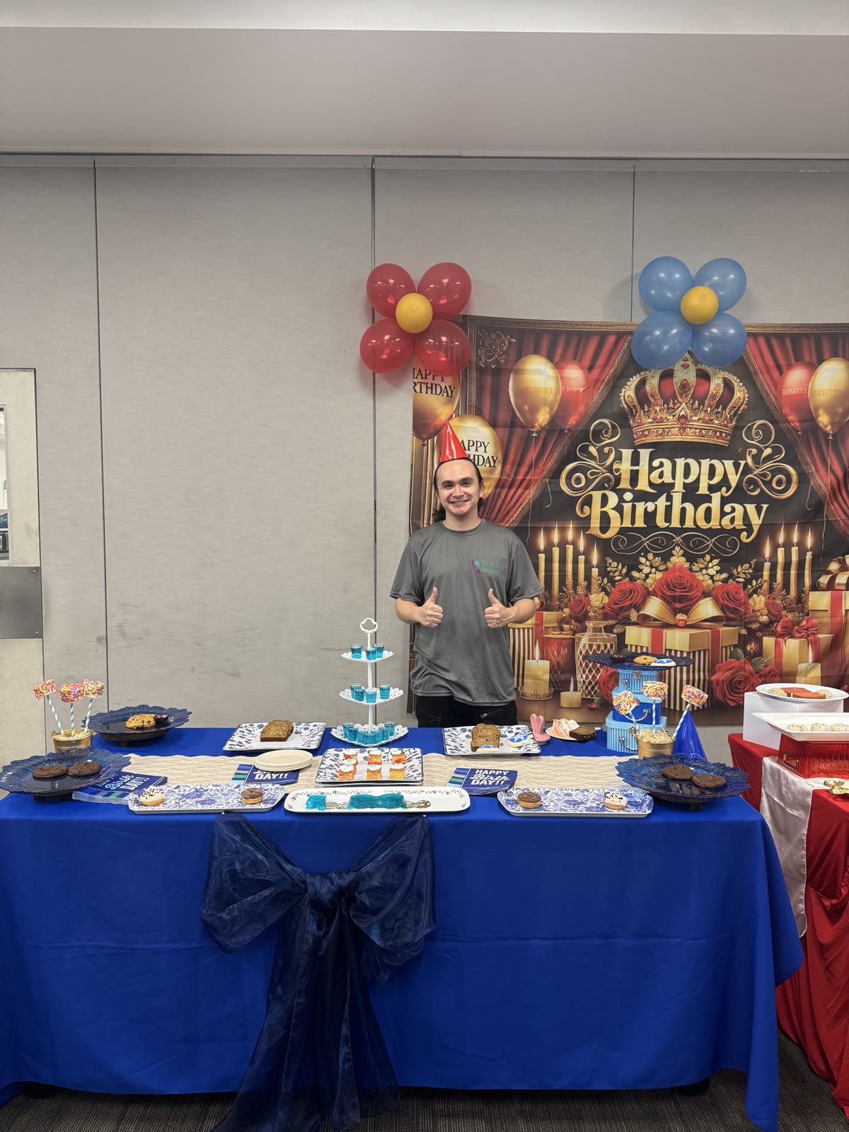 Guest of honor standing at his decorated birthday table