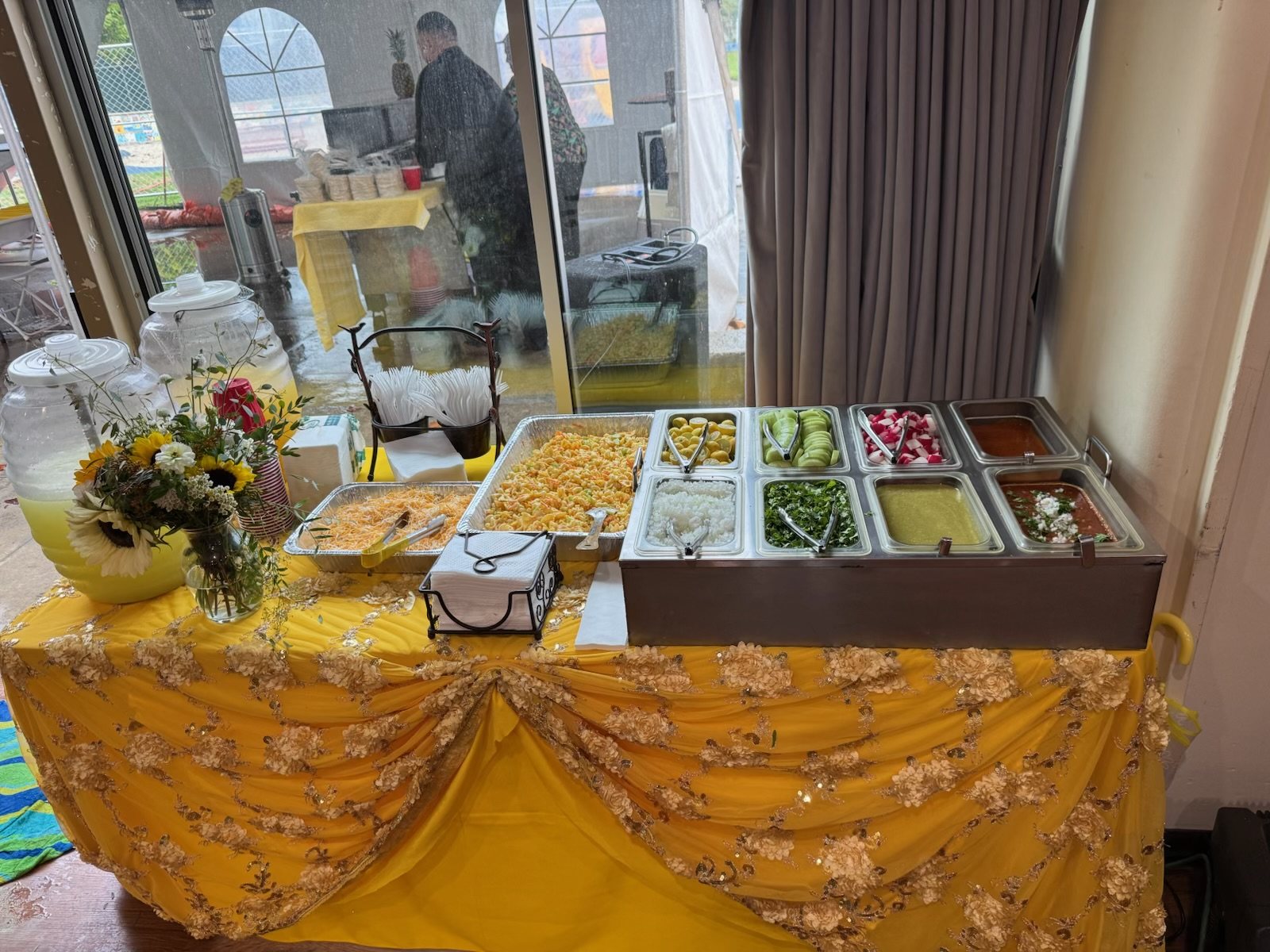 Buffet line dressed in gold linens with chafing dishes