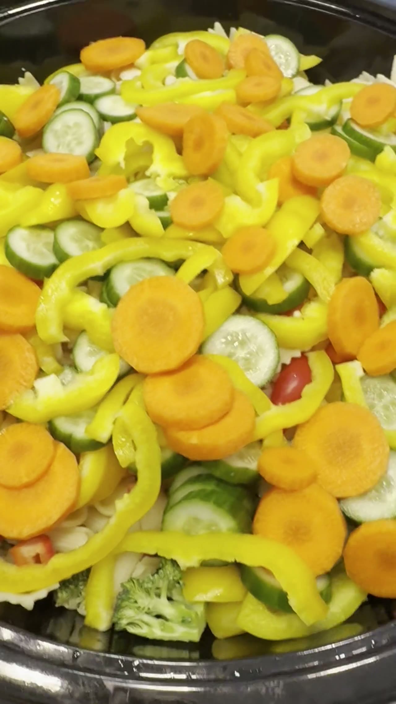 Platter of fresh cut bell peppers, carrots, cucumbers and broccoli
